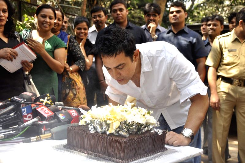 Aamir Khan blows his 45rd birthday candles as he celebrates his 45rd birthday with media today at his home in Mumbai.