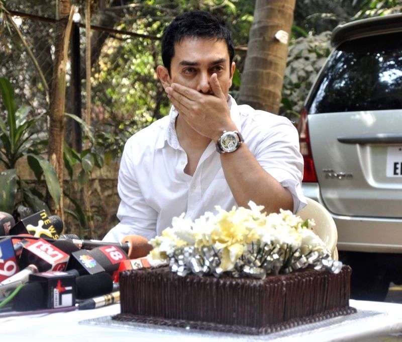 Aamir Khan gestures as he interacts with the media on his 45rd birthday at his home in Mumbai.
