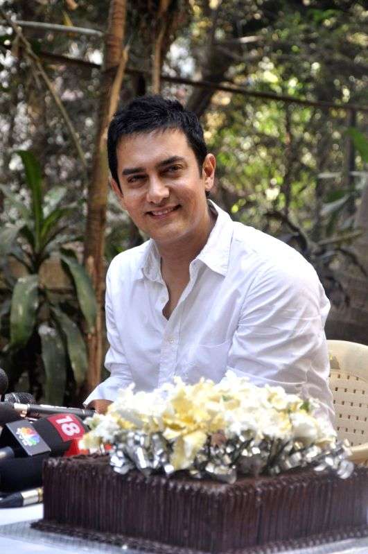 Aamir Khan smiles as he celebrates his 45rd birthday with media today at his home in Mumbai.