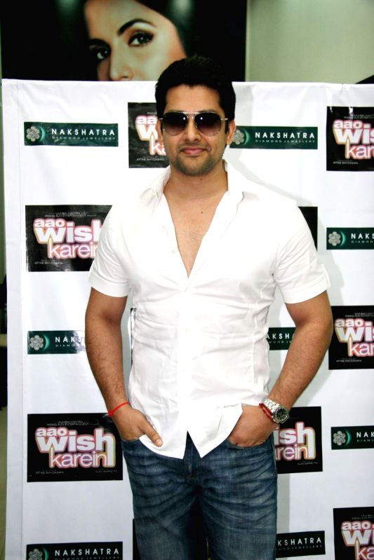 Bollywood Actor Aftab Shivdasani poses for the photographers during the celebration of Nakshatra’s brand success in Mumbai on Monday, 16 November 2009.