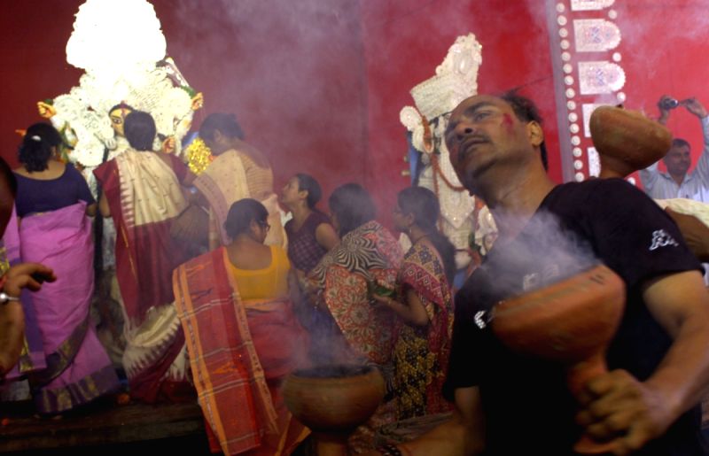 Devotees dancing on the beats of "Dhak" before the immersion of Goddess Durga at a puja pandal in East Delhi on Monday. (Photo: Partha Sarkar, IANS)
