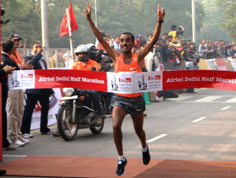Ethiopian athlete Deriba Merga reaches the finishing line. Mergia won the Airtel Delhi Half Marathon for men,in New Delhi on Sunday.