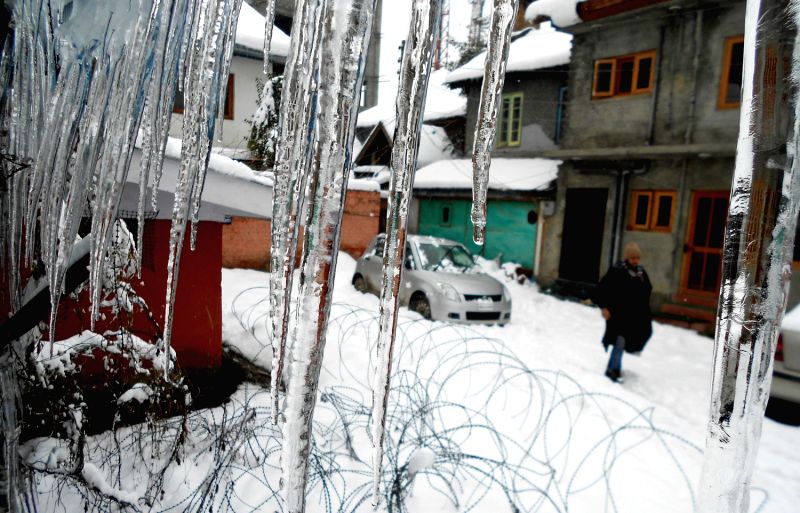 Icicles hang from rooftops as heavy snowfall blocked residential areas in Srinagar.