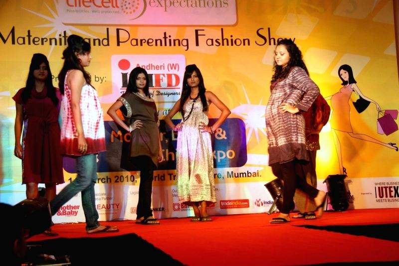 Pregnant women strike pose during Maternity and Parenting Fashion Show in Mumbai on Sunday,14 March 2010.