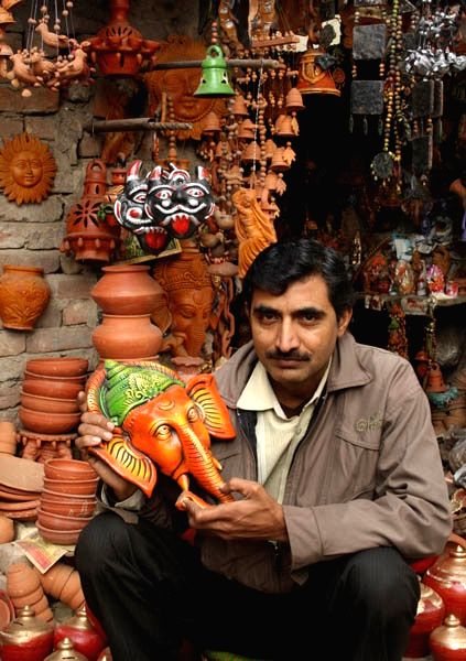 Raju shows Lord Ganesha's face which he imported from Kolkata.