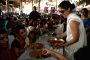 Kajol serves food to Rani Mukherjee at a Durga Pooja pandal in Mumbai.
