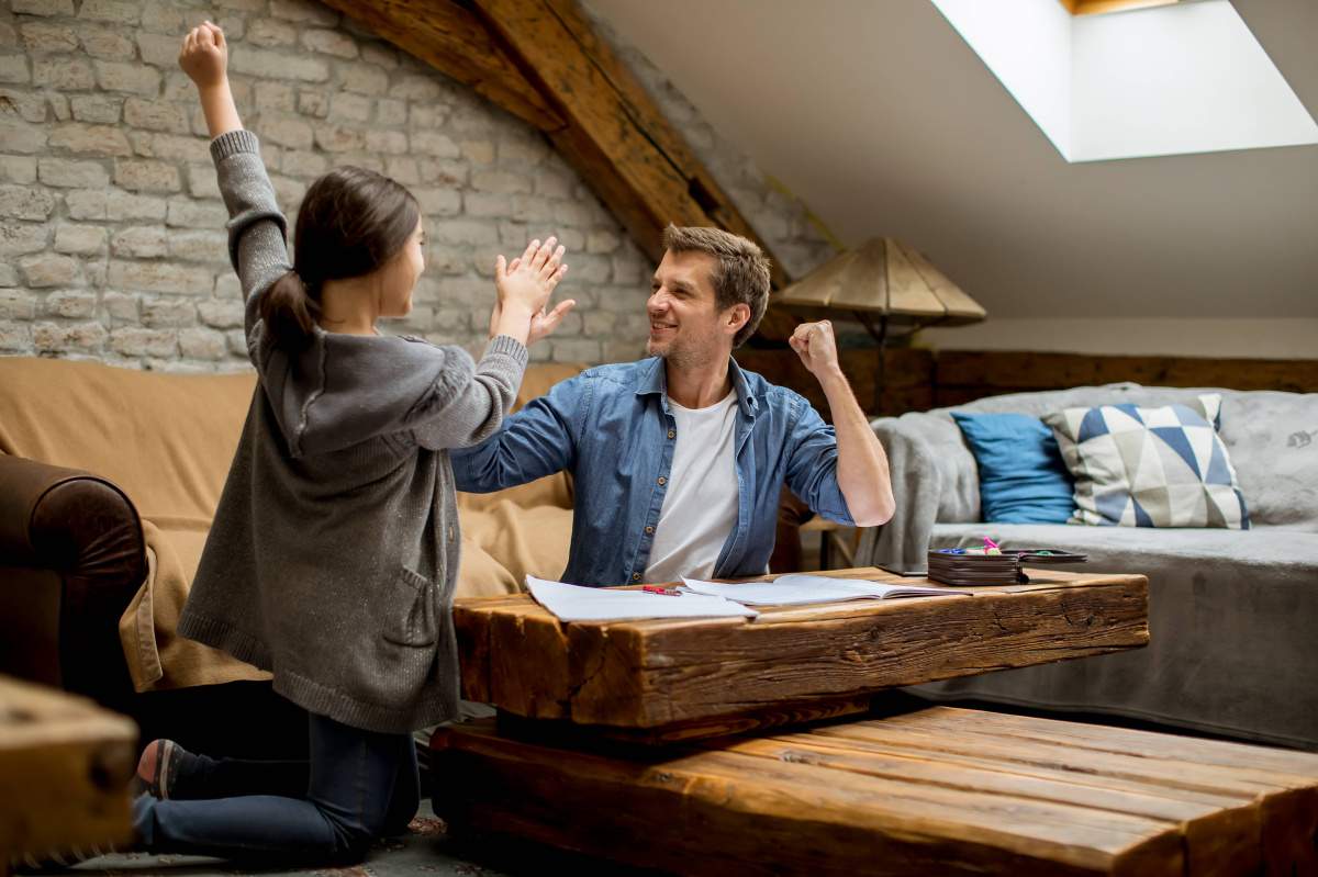 Girl and Man Celebrating at Home Together