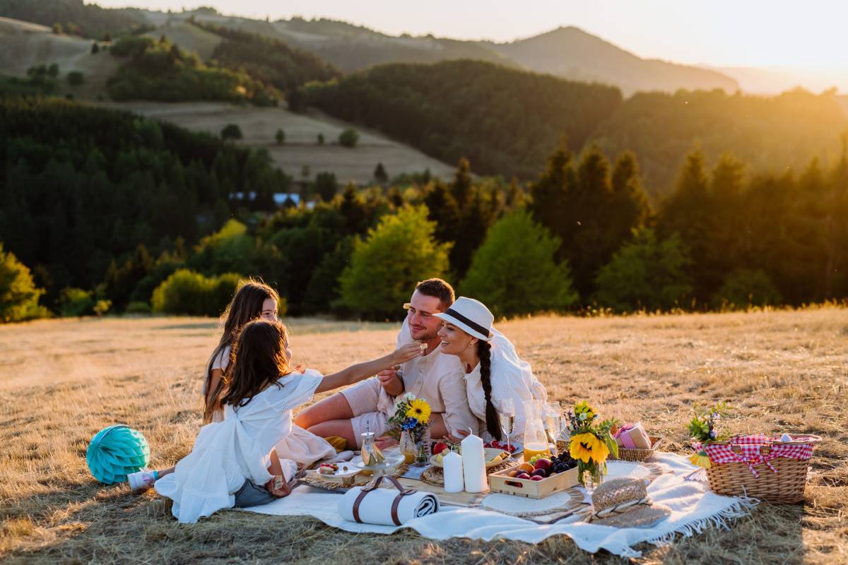 Happy Family Enjoying Golden Hour Picnic Outdoors