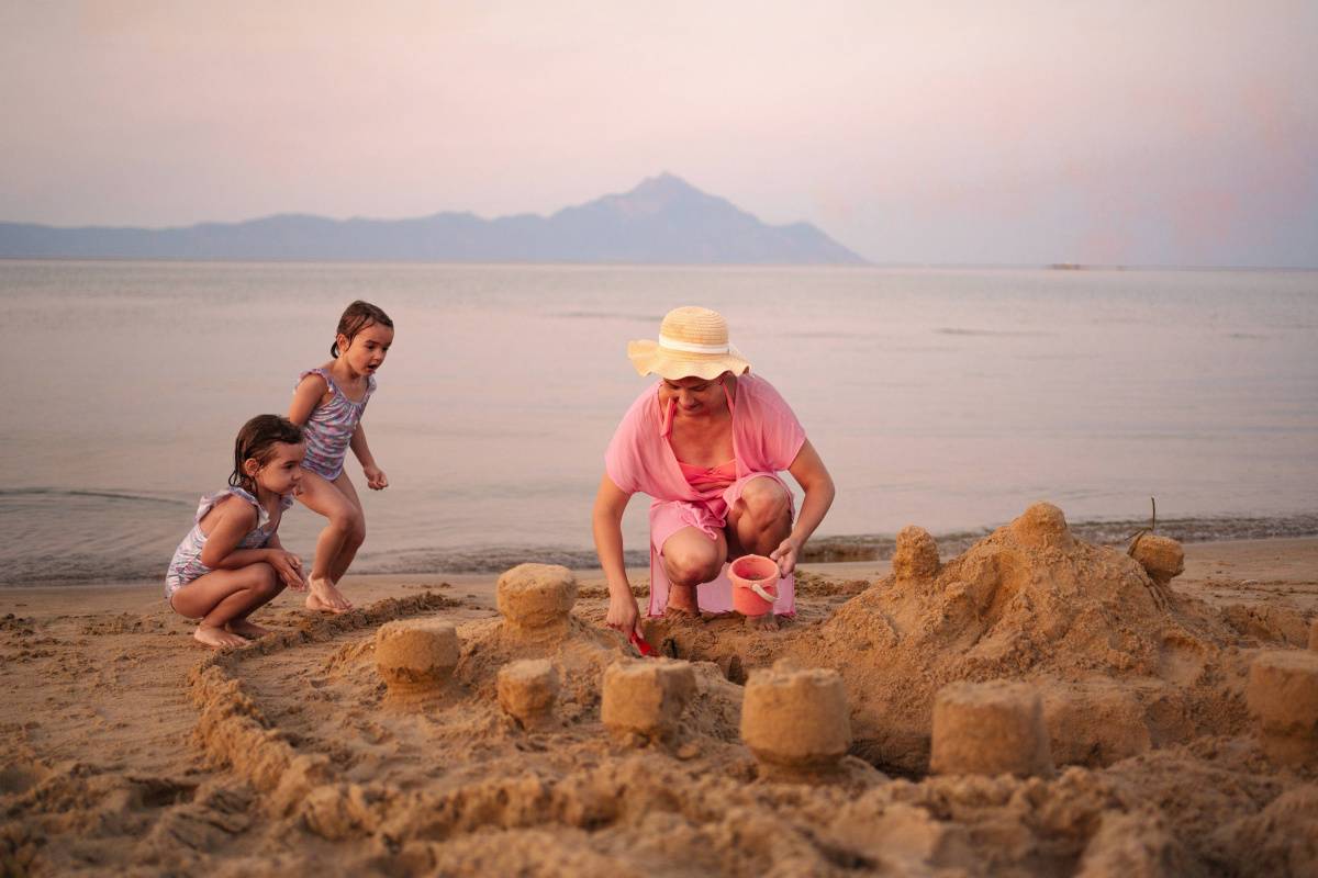 Mother and children creating sand castles