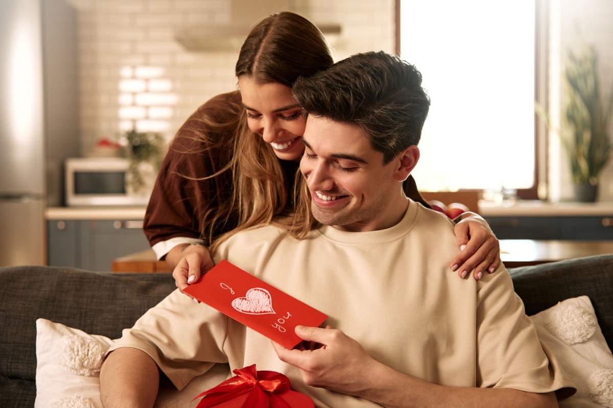 Smiling Couple with Romantic Card