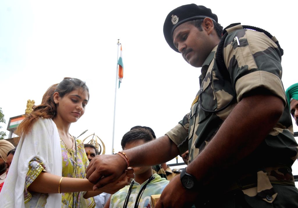 A girl ties 'Rakhi' on the wrist of BSF personnel