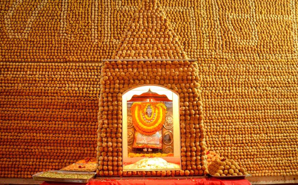 A grand display of 'Chhappan Bhog' offerings is arranged before the ...