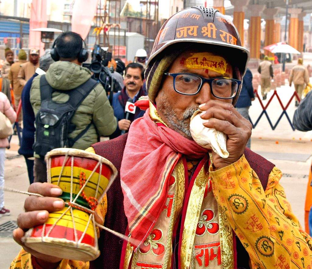 A Hindu devotee blows the 'Shankha' ahead of the Ram temple ...