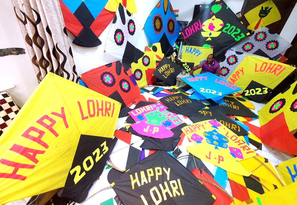 A kite maker prepares kites at his home-workshop