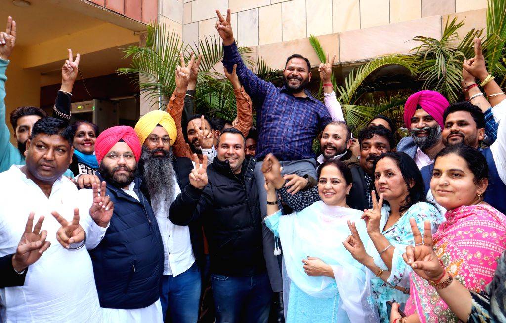 AAP councillor Kuldeep Kumar celebrates with party members after the ...