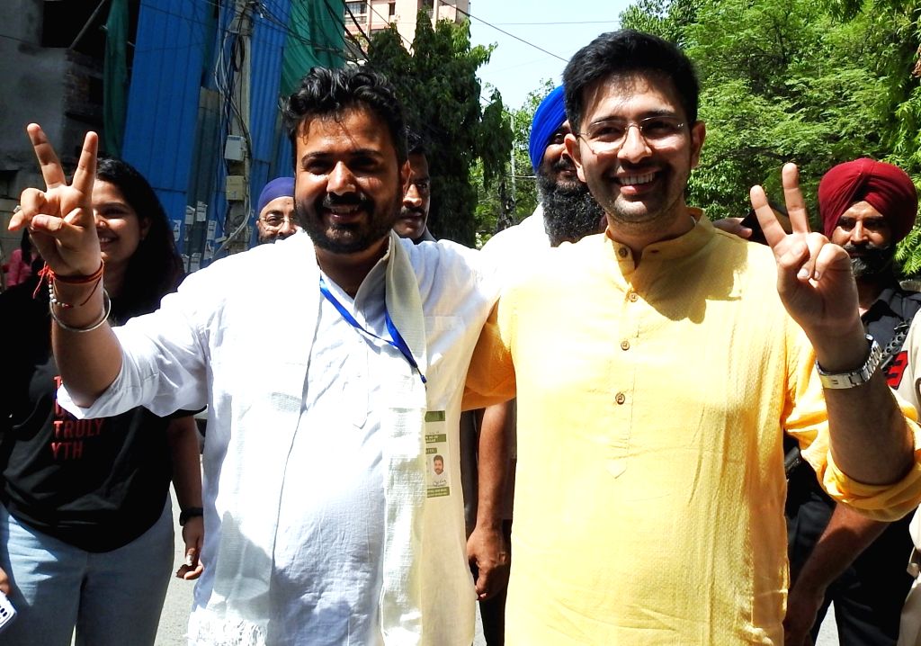 AAP MP Raghav Chadha with party candidate Durgesh Pathak pose for a picture