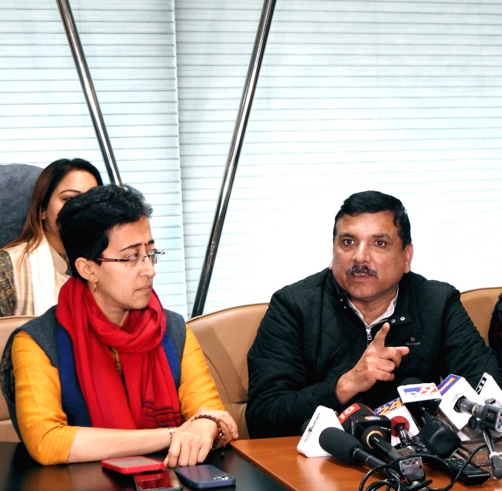 AAP MP Sanjay Singh along with party MLA Atishi Marlena address a press ...