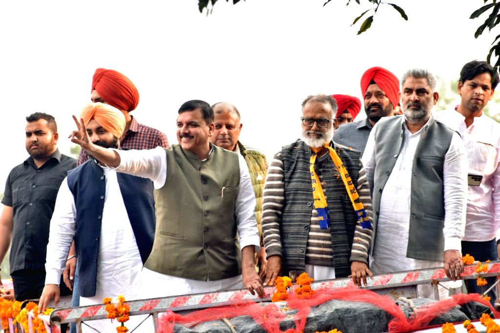 Kangra: AAP MP Sanjay Singh with party members during a roadshow ahead ...