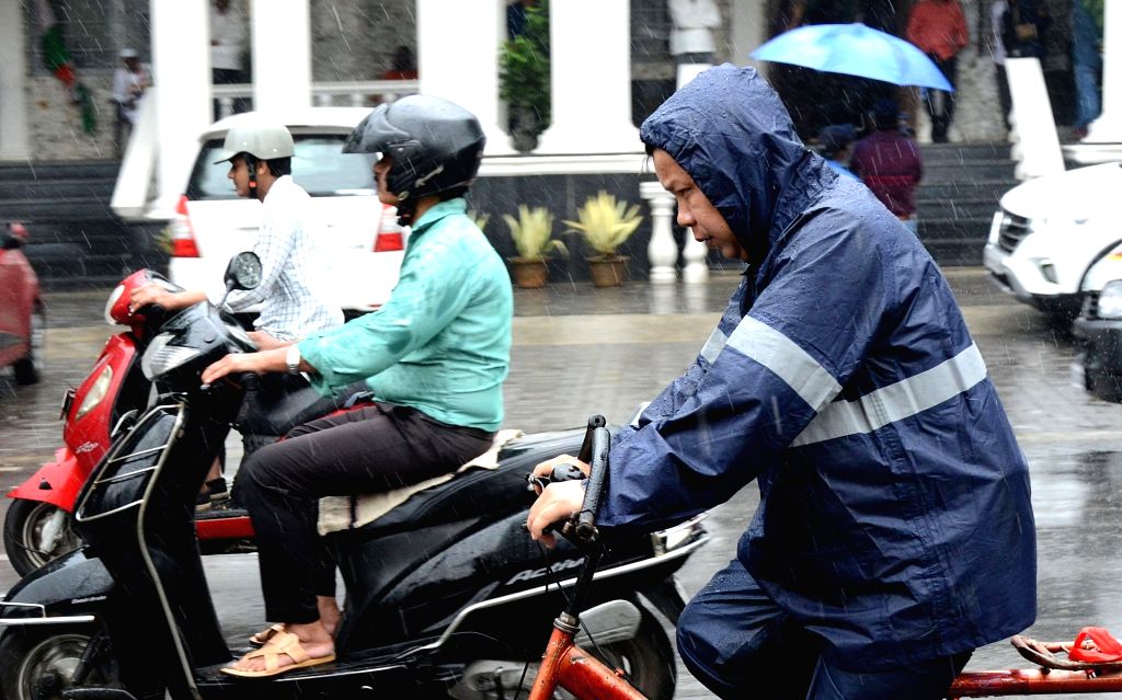 Bengaluru : A person riding his two wheeler amid rain