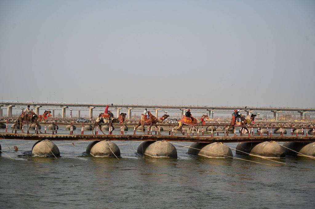Camel riders cross the pontoon bridge at Sangam after the conclusion of ...
