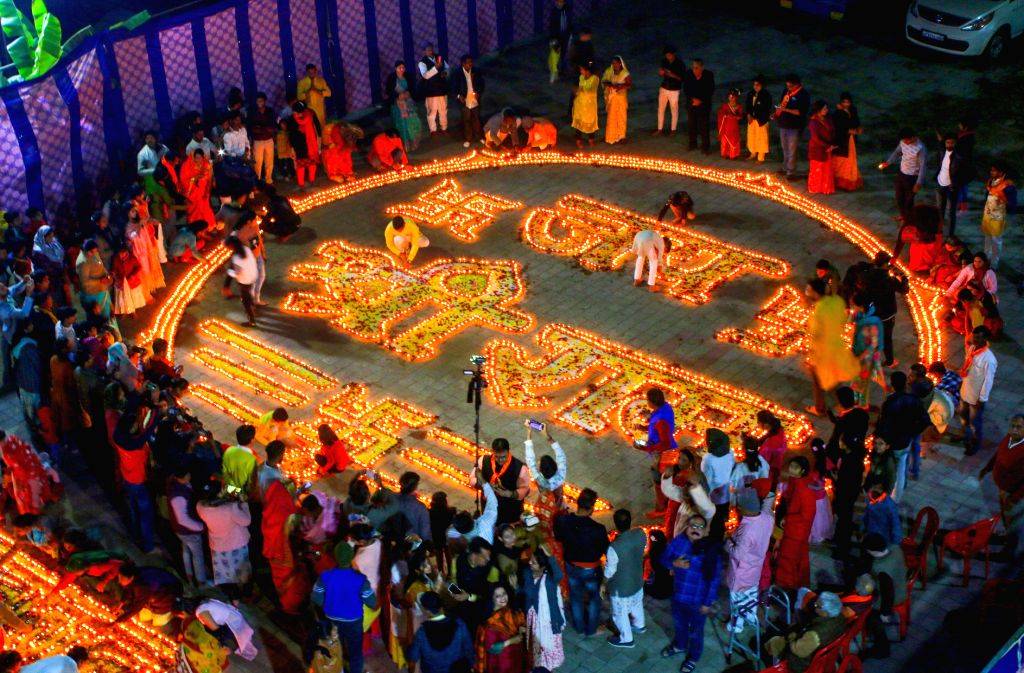 Devotees light 'diyas' (earthen lamps) on the occasion of the 'Pran ...
