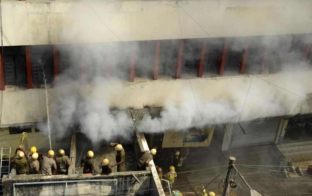 Fire fighters fighting against fire that broke out in a commercial ...