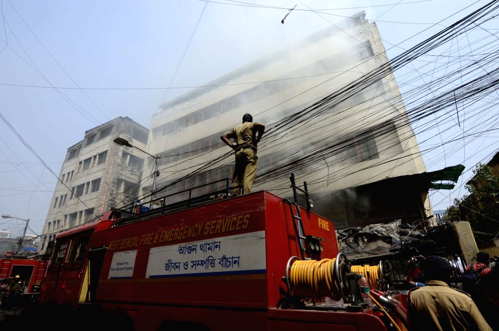 Fire fighters fighting against fire that broke out in a commercial ...