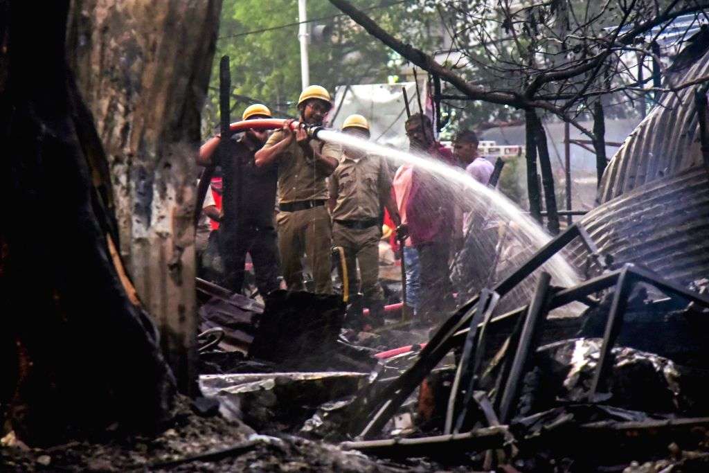 Firefighters attempt to douse a fire that broke out at Lords More Bazaar