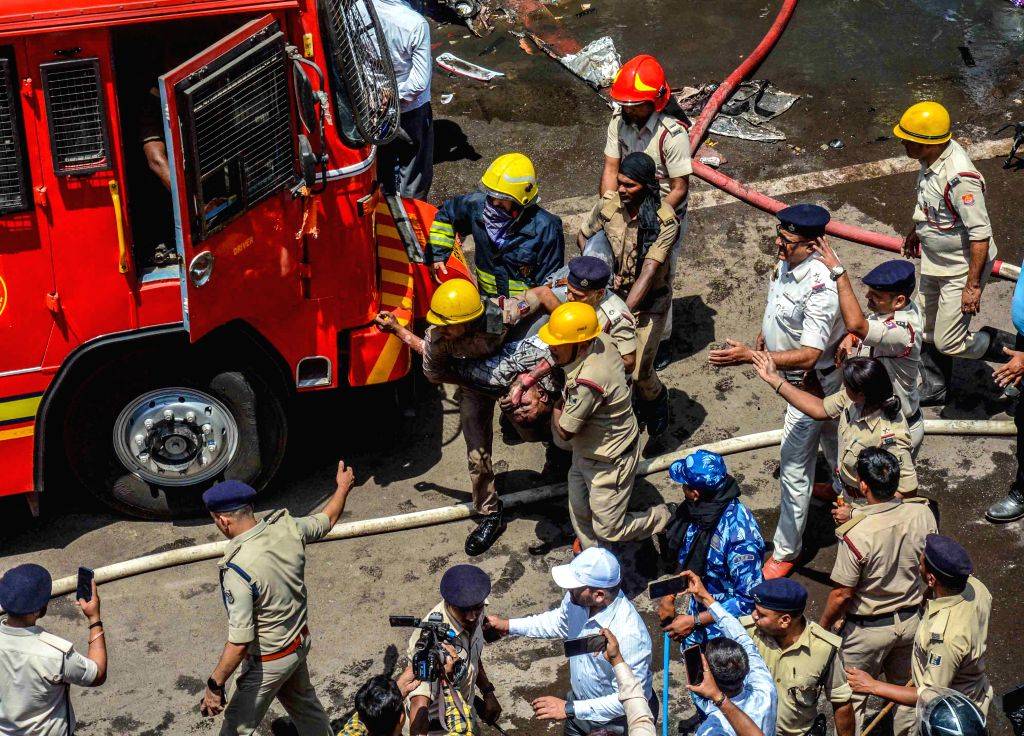 Firefighters douse a fire which broke out in a hotel near the Patna ...