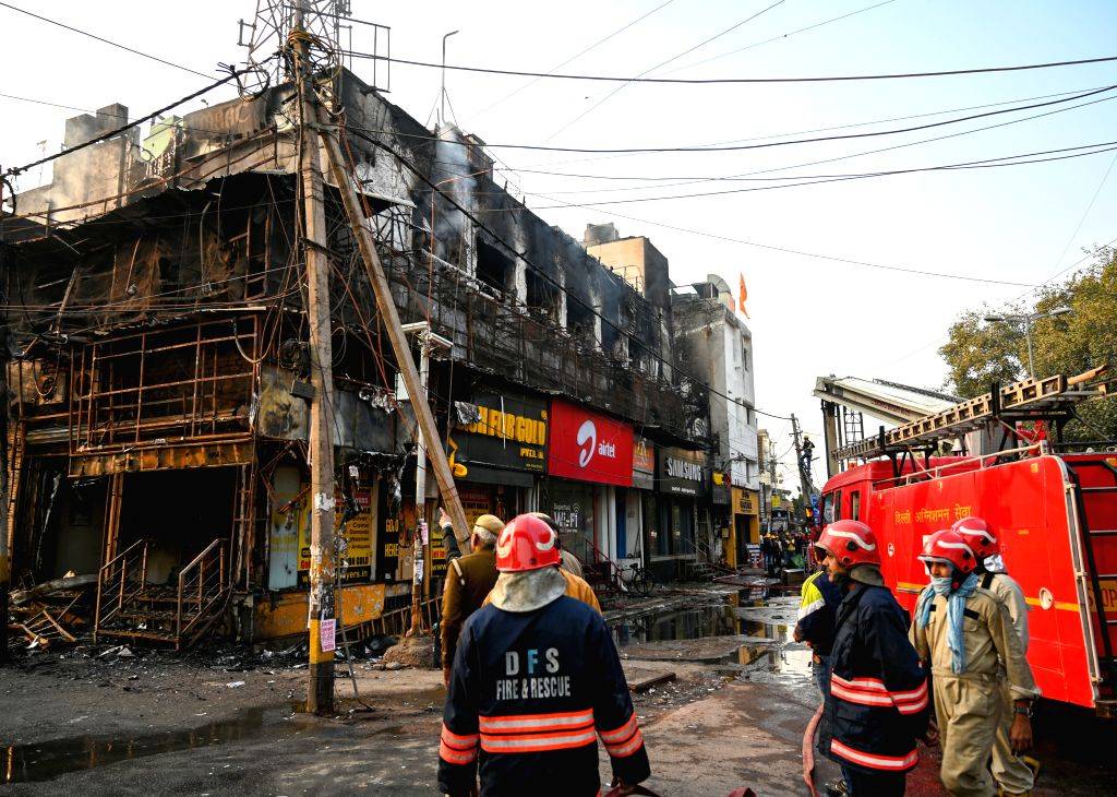 Firefighters try to douse a fire that broke out at a restaurant in West ...