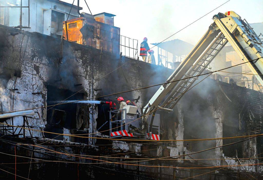 Firefighters try to douse a fire that broke out at a restaurant in West ...