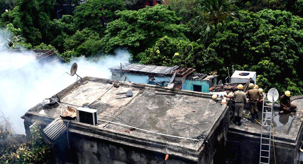 Firefighters try to extinguish the fire after fire broke out at a building