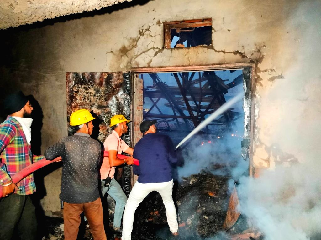 Firefighters trying to douse the fire after it broke out at Aanam Theatre
