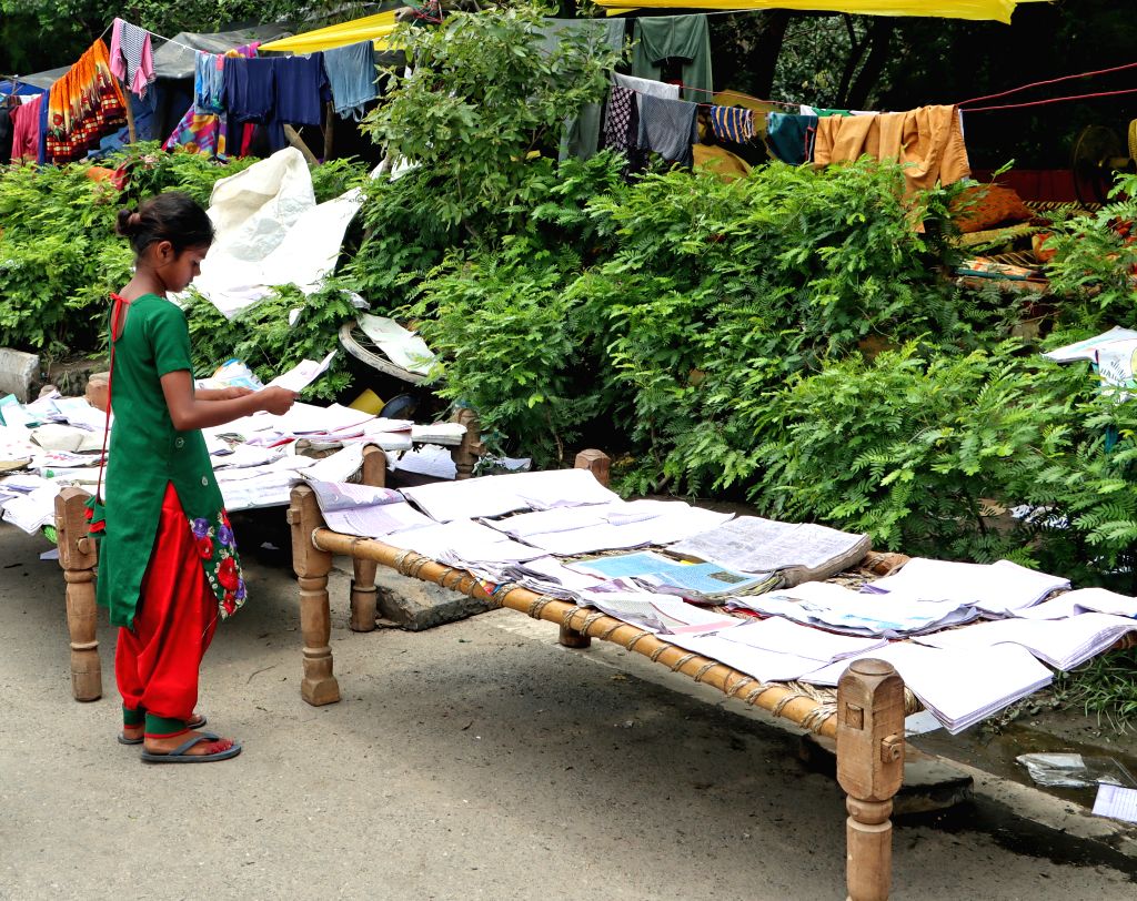 Flood affected Children dry their school books
