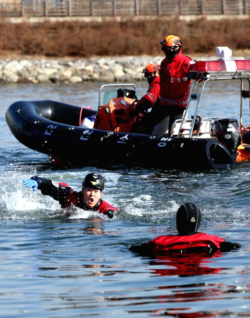 : Incheon : A rescue worker swims toward a simulated drowning man ...
