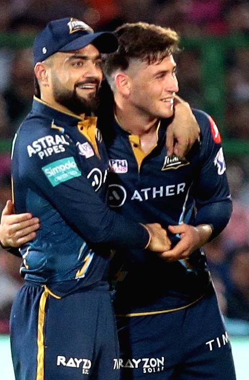 Jaipur : GT bowler Noor Ahmad with teammate Rashid Khan celebrate the ...