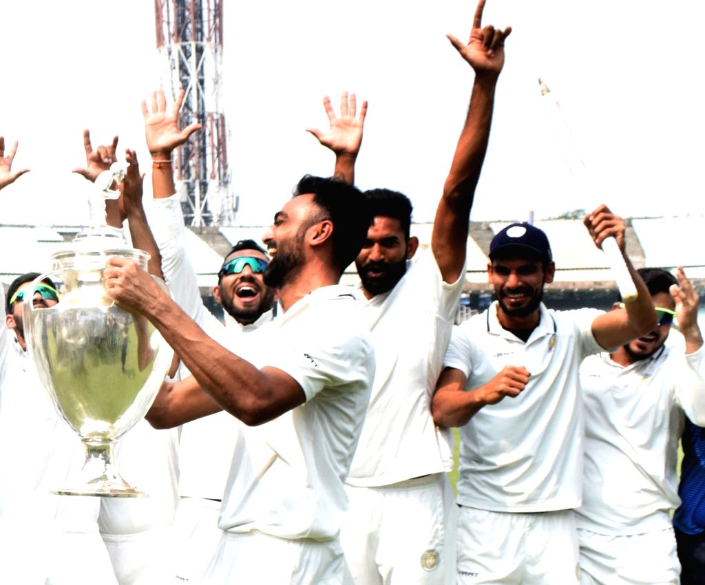 :Kolkata: Saurashtra captain Jaydev Unadkat hold the trophy as he ...