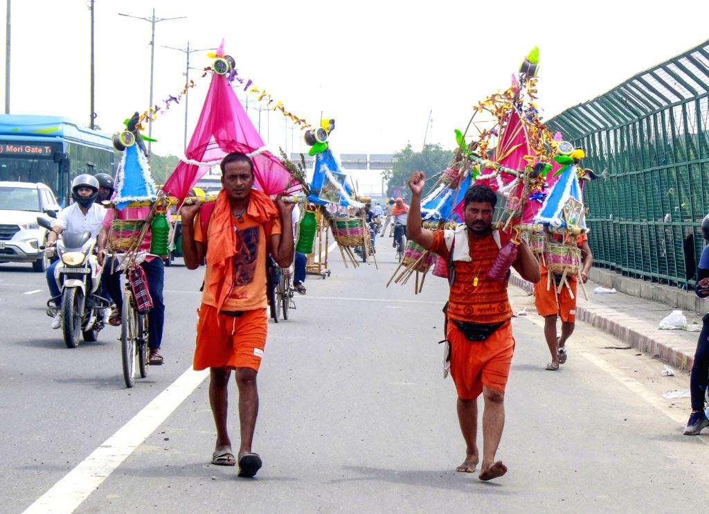 Lord Shiva devotees or a 'Kanvariya' carries holy water from ganga during  Kawar yatra in the month ...
