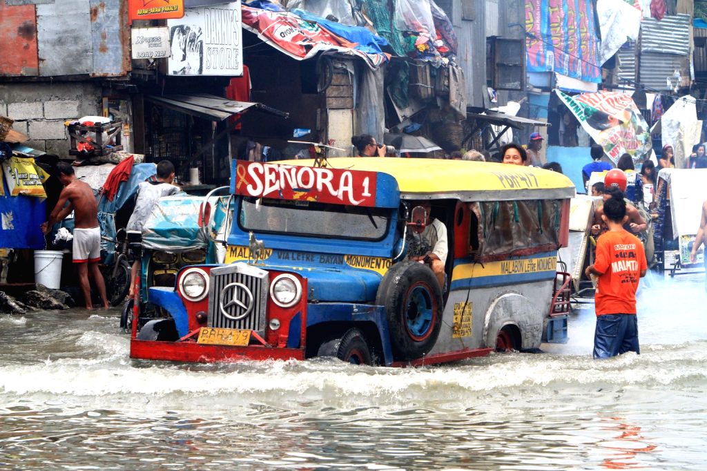 A vehicle moves through the flood in Malabon City