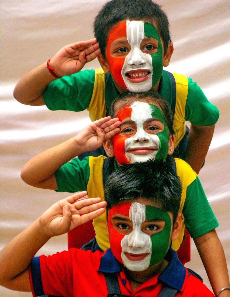 Meerut : Children paint their face in the colors of the Indian national ...