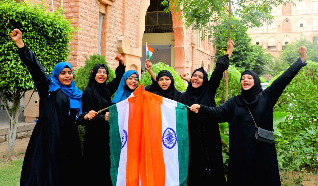 Muslim Women holds national flag during the during the 77th ...