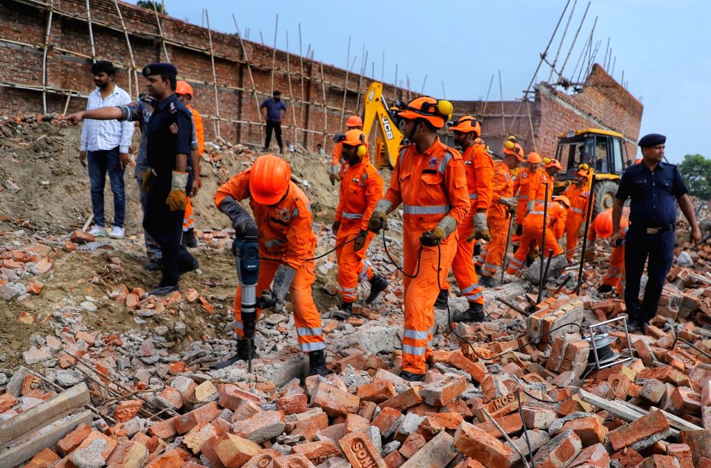 Ndff Rescue NDRF personnel during a rescue operation after a wall of an under ...