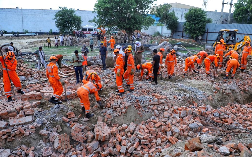 Ndff Rescue NDRF personnel during a rescue operation after a wall of an under ...