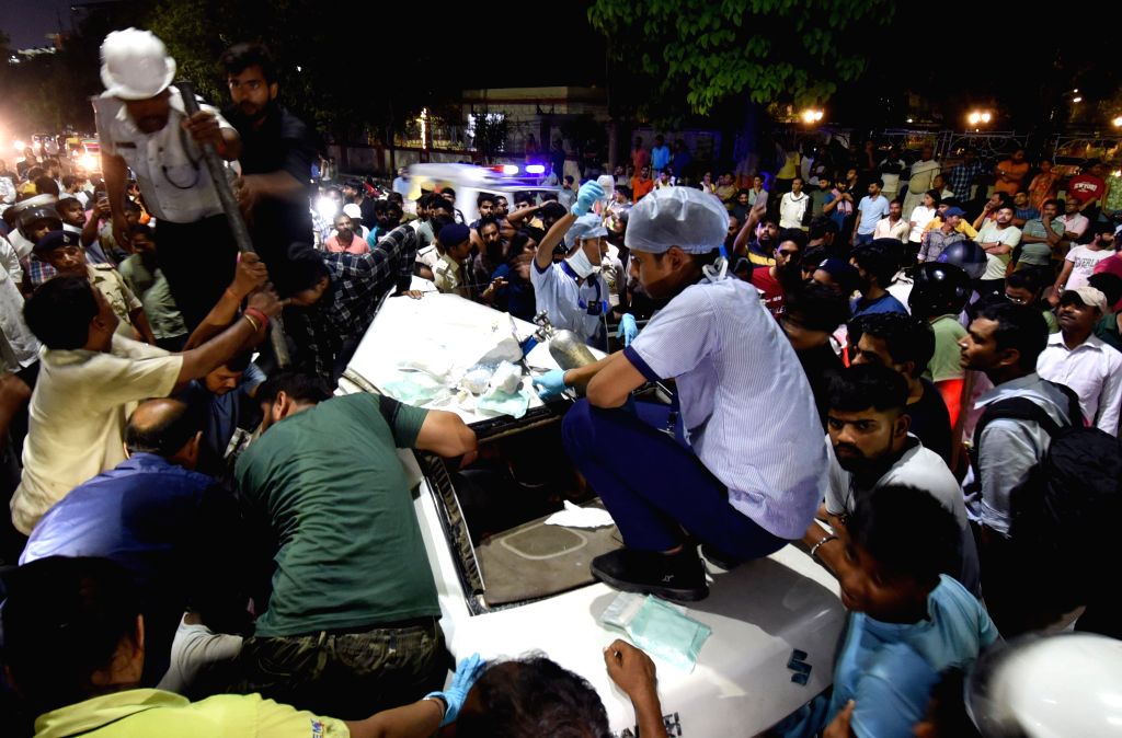 People attempt to rescue injured after a collision between two cars