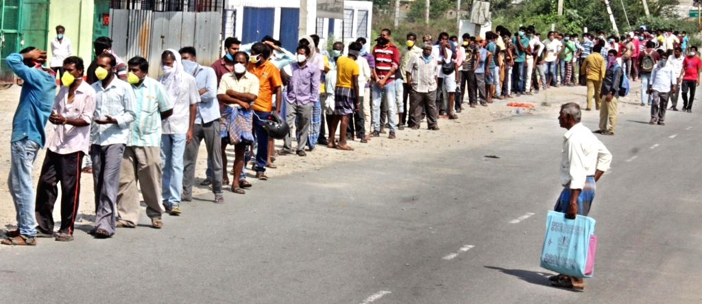 People wait in long queues to buy liquor during lockdown