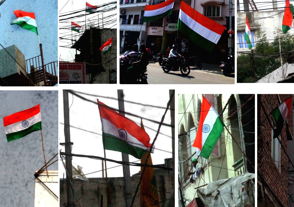 People hoist national flag outside their homes