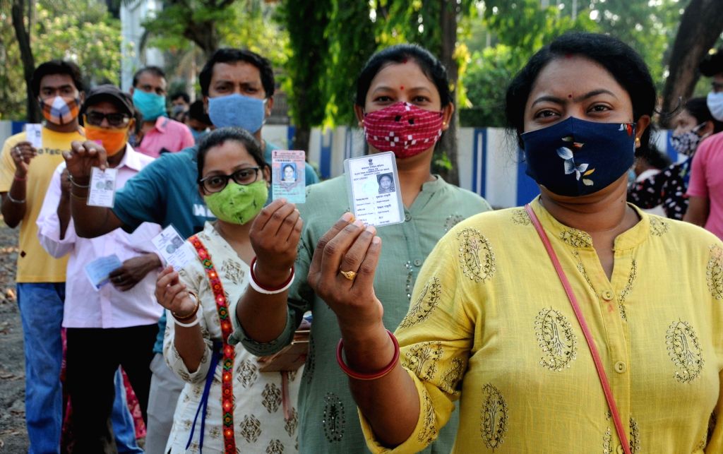 People stand in a queue at a polling station to cast their vote during ...