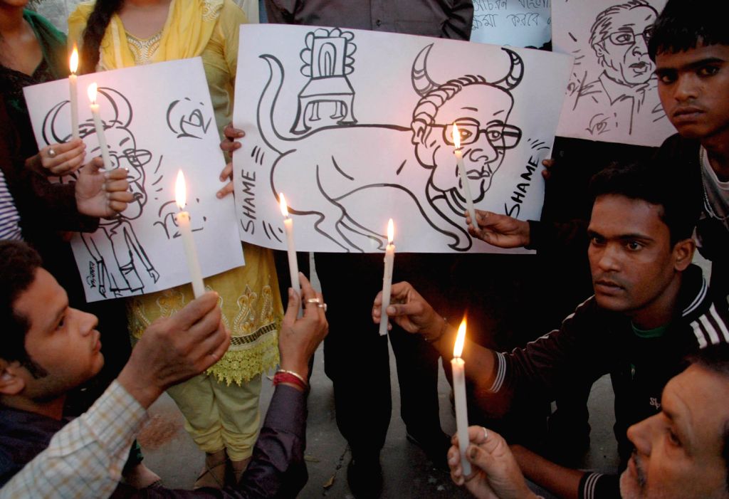 People take part in a candle rally to protest against Justice Asok ...