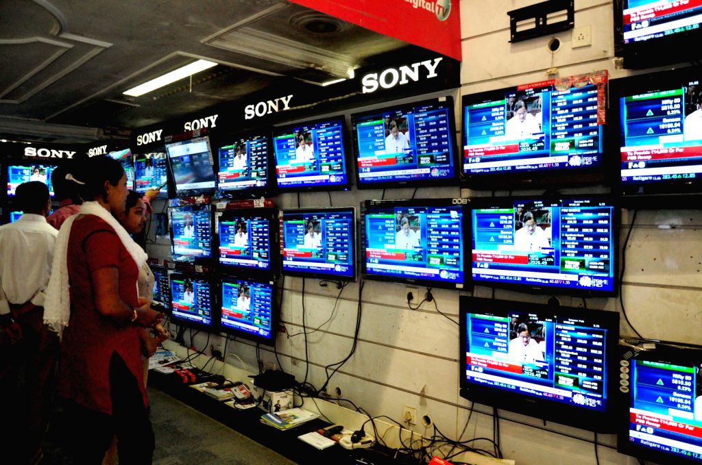 People watch the live telecast at a television showroom