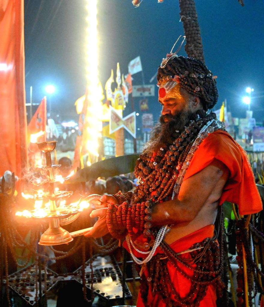 A sadhu performs rituals and offers prayers during Maha Kumbh Mela 2025